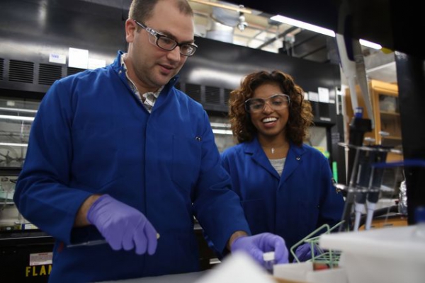 Photo of Justin Caram, assistant professor of chemistry and biochemistry in the UCLA College, and graduate student Dayanni Bhagwandin.