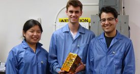 Bruin Space team members Chloe Liau, Andrew Evans, and Alexander Gonzalez holding their final flight model.