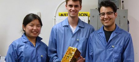 Bruin Space team members Chloe Liau, Andrew Evans, and Alexander Gonzalez holding their final flight model.