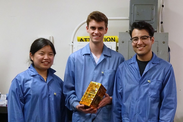 Bruin Space team members Chloe Liau, Andrew Evans, and Alexander Gonzalez holding their final flight model.