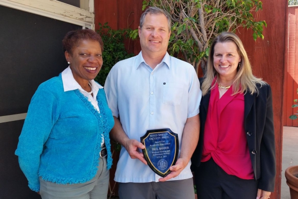 Coretta Harris, left, chair of the 2019 Gold Shield Faculty Prize Committee; Paul Barber; and Karen Sears, ecology and evolutionary biology department chair, who nominated Barber for the award.