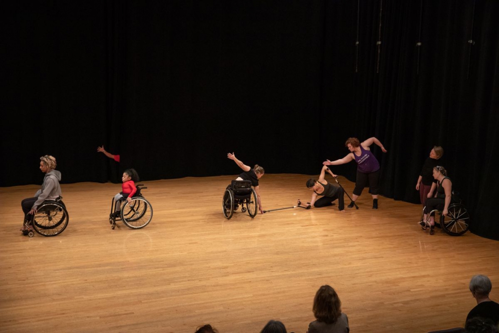 Photo of a group of dancers performing on stage,