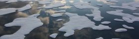 Picture of melting ice in body of water.