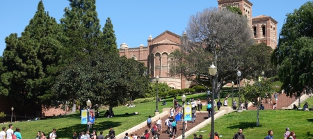 A photo of students on the UCLA campus, with the Janss Steps and Royce Hall in the background.