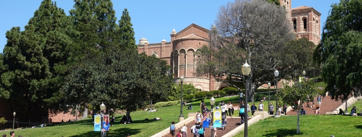 A photo of students on the UCLA campus, with the Janss Steps and Royce Hall in the background.