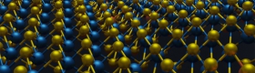 A photo of a 3D atomic structure information of a 2D material that was previously inaccessible due to the limitations of 2D images. A 2D image is shown beneath the 3D atomic coordinates of molybdenum in blue, sulfur in yellow and rhenium dopants in orange.