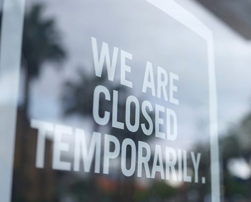 A photo of a storefront with a sign that says "We are closed temporarily."