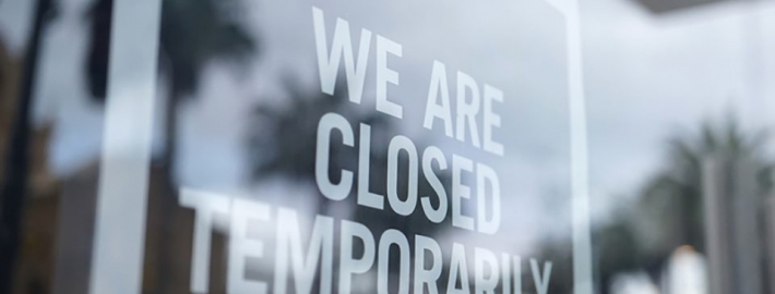 A photo of a storefront with a sign that says "We are closed temporarily."