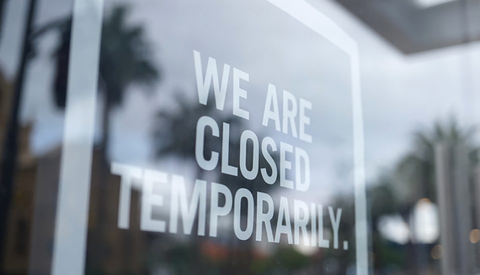 A photo of a storefront with a sign that says "We are closed temporarily."