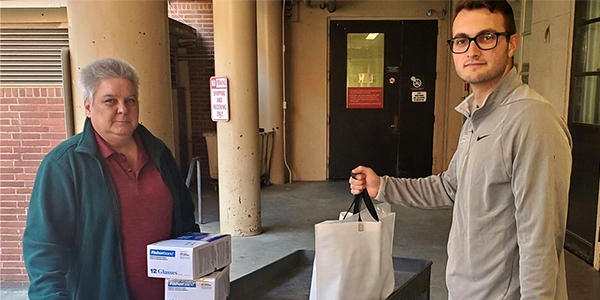 A photo of a first responder receives safety glasses and goggles. 