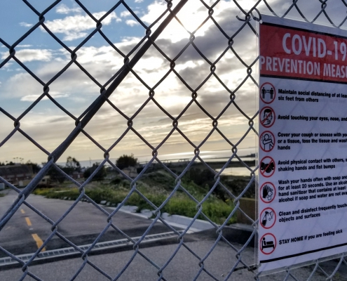 A photo of a Covid-19 fence sign.