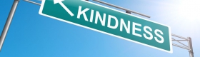 A photo of a street sign named "Kindness."