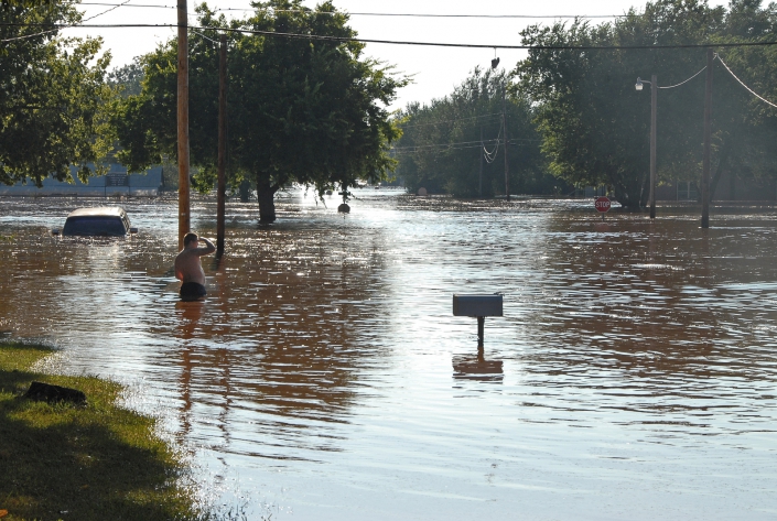 Man wades in flood waters to look for realitives. A photo of flood waters caused by Tropical Storm Erin in Kingfisher, Oklahoma, in August 2007.
