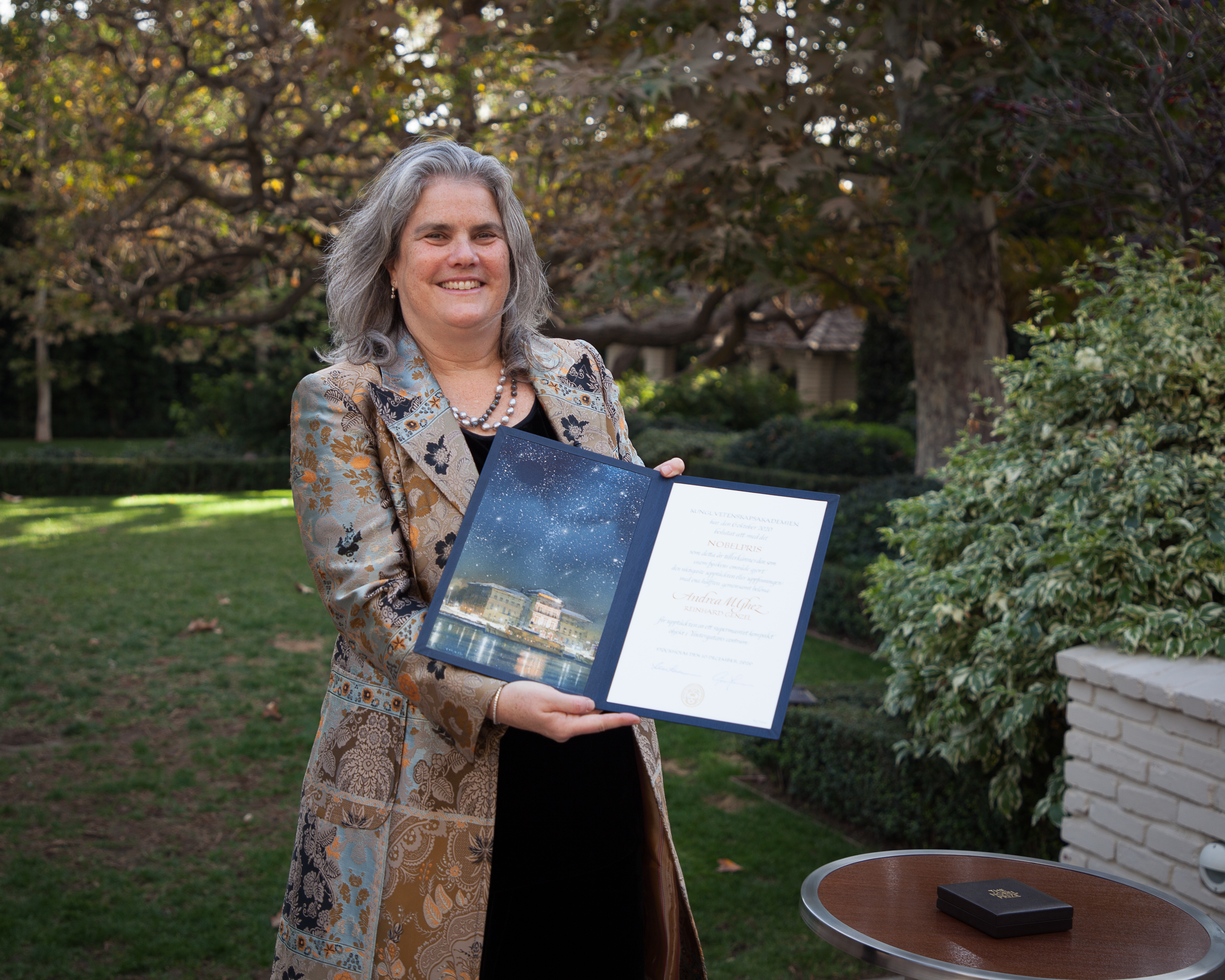 A photo of Andrea Ghez receiving her Nobel Prize citation and medal. 
