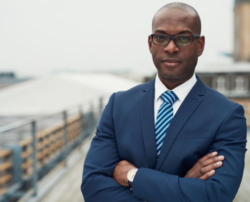 A photo of a Black man in suit and tie.