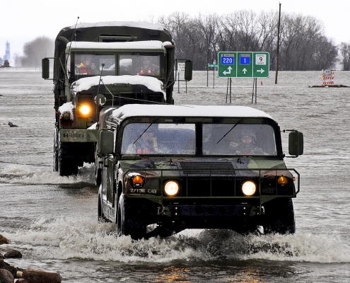 Military vehicles traveling through a flooded street in Minnesota. Photo Credit: Tech. Sgt. Erik Gudmundson/U.S. Air Force