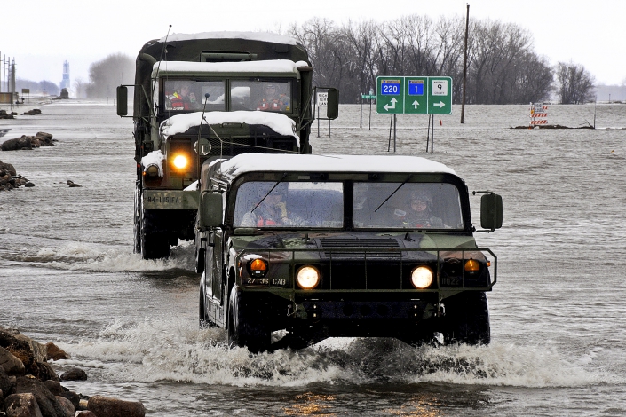 Military vehicles traveling through a flooded street in Minnesota. Photo Credit: Tech. Sgt. Erik Gudmundson/U.S. Air Force Military vehicles traveling through a flooded street in Minnesota. Photo Credit: Tech. Sgt. Erik Gudmundson/U.S. Air Force