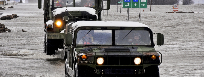 Military vehicles traveling through a flooded street in Minnesota. Photo Credit: Tech. Sgt. Erik Gudmundson/U.S. Air Force