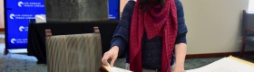 Professor Marissa López examines Robert Becker’s "Diseños of California Ranchos: Maps of thirty-seven Land Grants if 1822-1846 from the Records of the United States District Court, San Francisco" in the Rare Books room at Central Library downtown. PHOTO CREDIT: Yvonne Condes