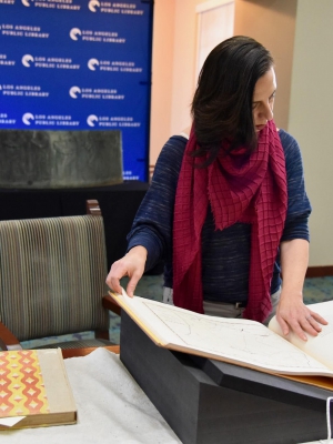 Professor Marissa López examines Robert Becker’s "Diseños of California Ranchos: Maps of thirty-seven Land Grants if 1822-1846 from the Records of the United States District Court, San Francisco" in the Rare Books room at Central Library downtown. PHOTO CREDIT: Yvonne Condes
