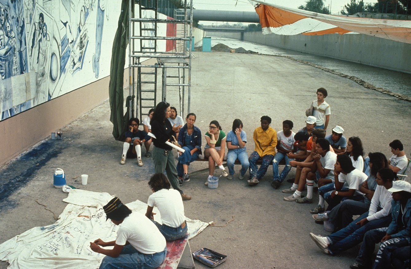 Image of mural makers meeting at "The Great Wall of Los Angeles," painted in the summer of 1981
