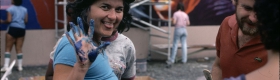 An image of Judy Baca at “The Great Wall of Los Angeles” in the summer of 1983.