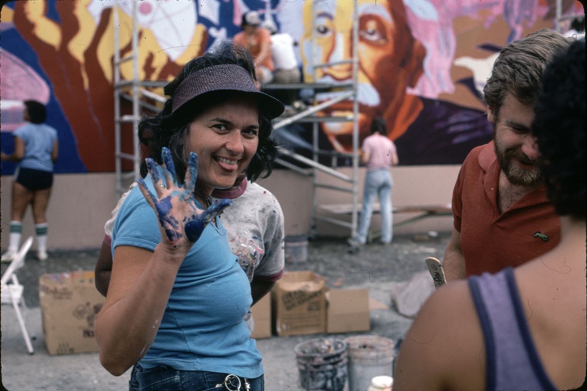 An image of Judy Baca at “The Great Wall of Los Angeles” in the summer of 1983.