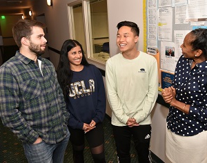 Image of Angela Deaver Campbell with three 2019 graduates who benefited from the Scholarship Resource Center’s support, Wesley Armstrong, Sereena Nand and Austin Lee.