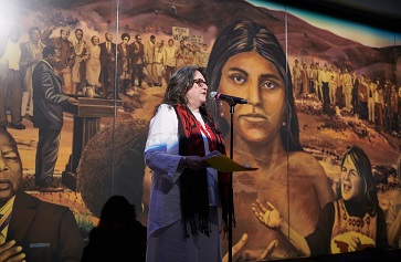 Image of Judith Baca, UCLA professor emeritus of Chicana and Chicano and Central American studies and of world arts and cultures, at the unveiling of her mural “La Memoria de la Tierra: UCLA.” Image credit: Don Liebig/ASUCLA