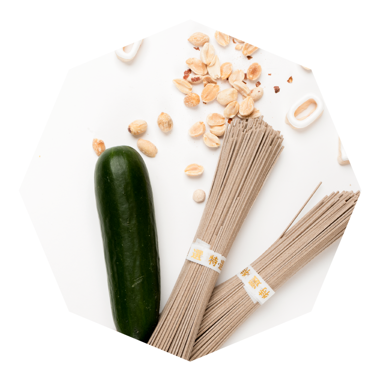 Image of dry noodles, a zucchini and peanuts used in a meal kit.