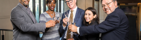 Image of the five UCLA College deans raising a toast.