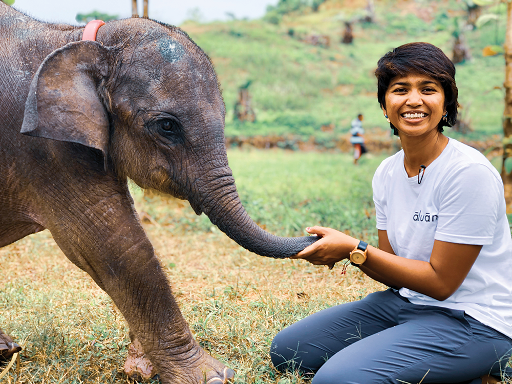 Image of Farwiza Farhan alongside a baby elephant.