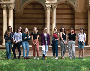 Portrait of nine members of the Society of Gender Equity in Geosciences at standing in front of Royce Hall