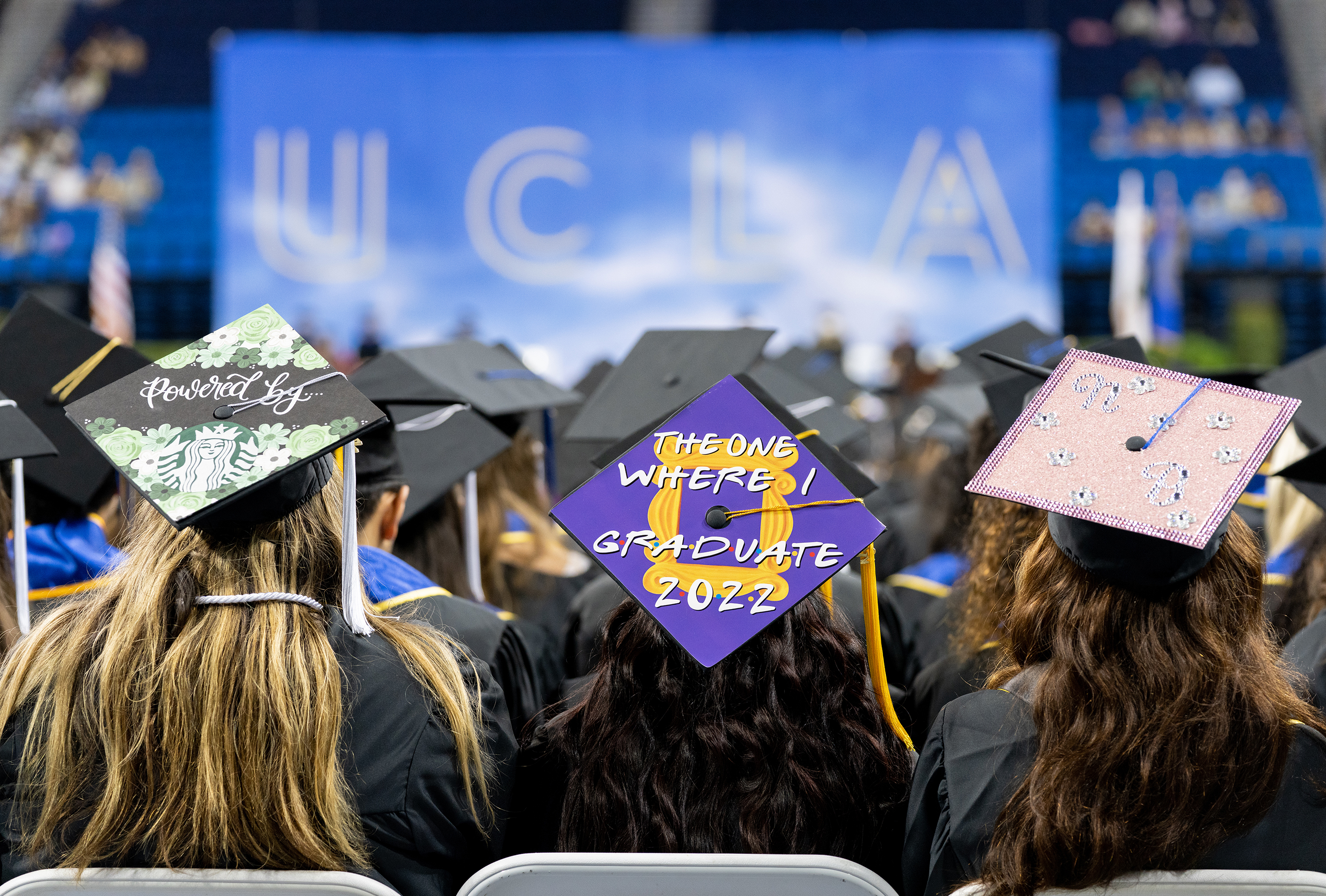 Image of students wearing decorated graduation caps