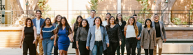 Wide shot of 16 LPPI staff, faculty and fellows of LPPI on campus