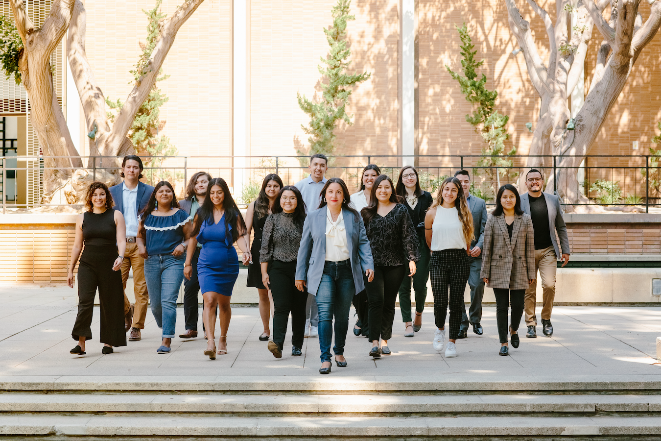 Wide shot of 16 LPPI staff, faculty and fellows of LPPI on campus