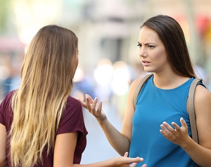 Two friends talking seriously on the street