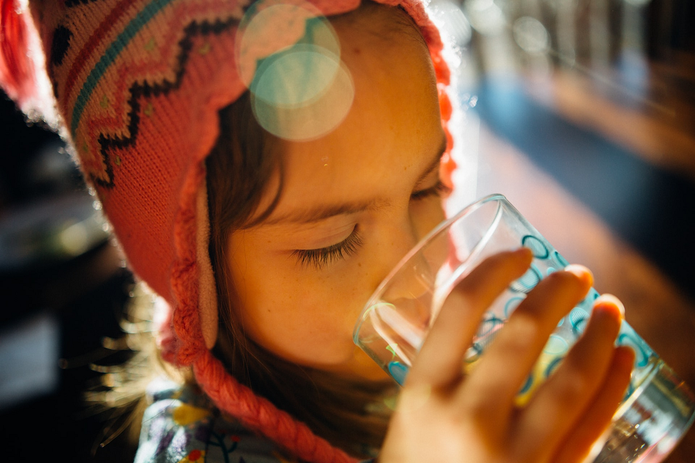 Image of a child drinking a glass of water