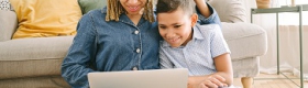 Woman and boy on floor with laptop