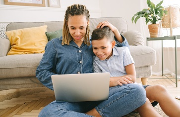 Woman and boy on floor with laptop