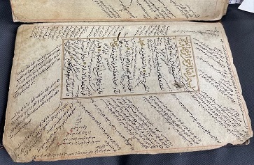 Image of Manuscript of religious commentary. In this image, al-Taftāzānī’s sharḥ (commentary) on al-Nasafī’s al-ʿAqāʾid al-Nasafīyya (the creed of an-Nasafī) can be seen within the textblock. In the marginalia and between the text, glosses on this commentary and intertextual references by several different scholars can be found.