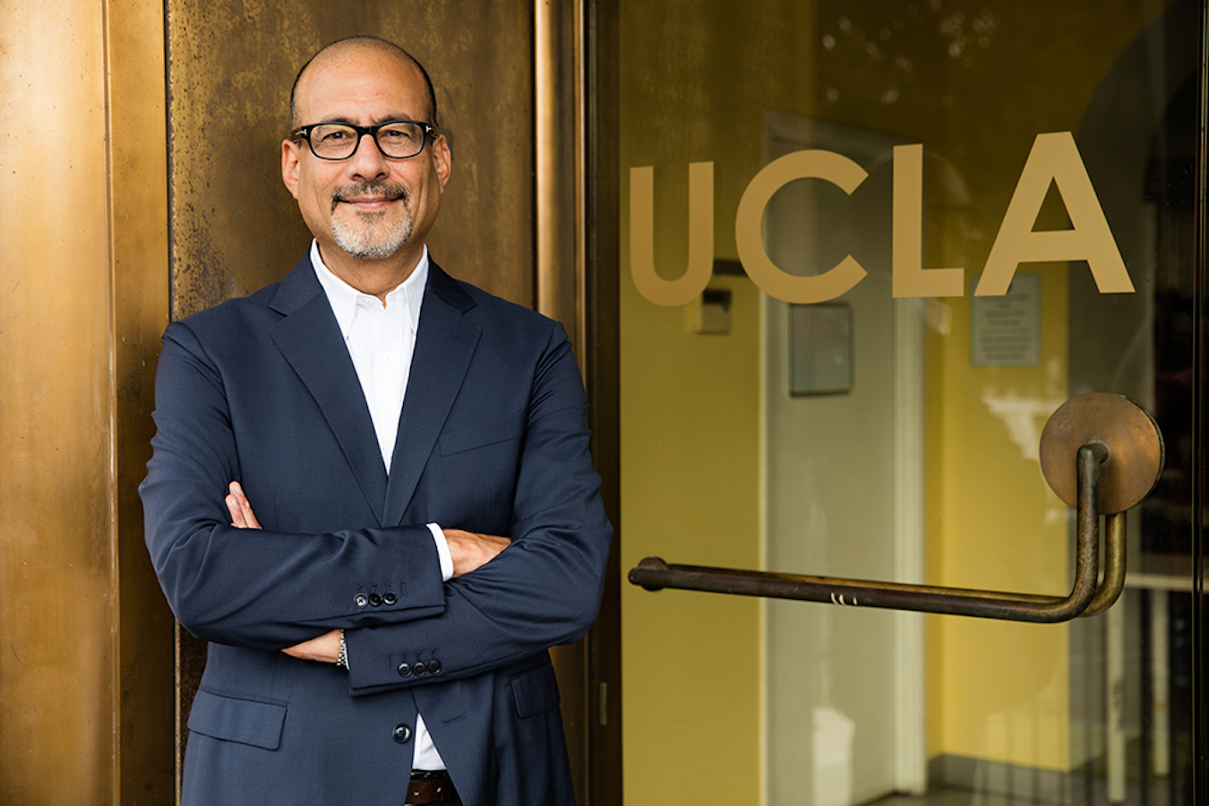 Abel Valenzuela in front of door reading "UCLA"