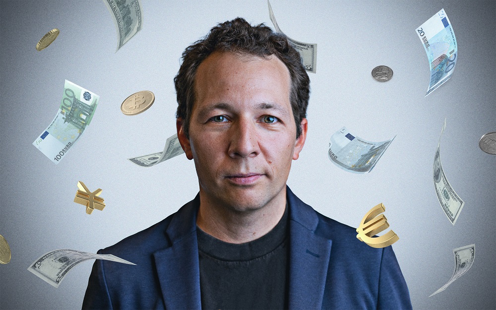 Oleg Itskhoki, UCLA’s Venu and Ana Kotamraju Professor of Economics, surrounded by floating currencies.