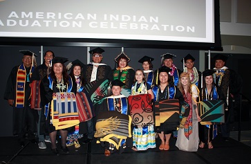 Graduates wearing caps and gowns at the 2-18 American Indian Studies graduation ceremony at UCLA.