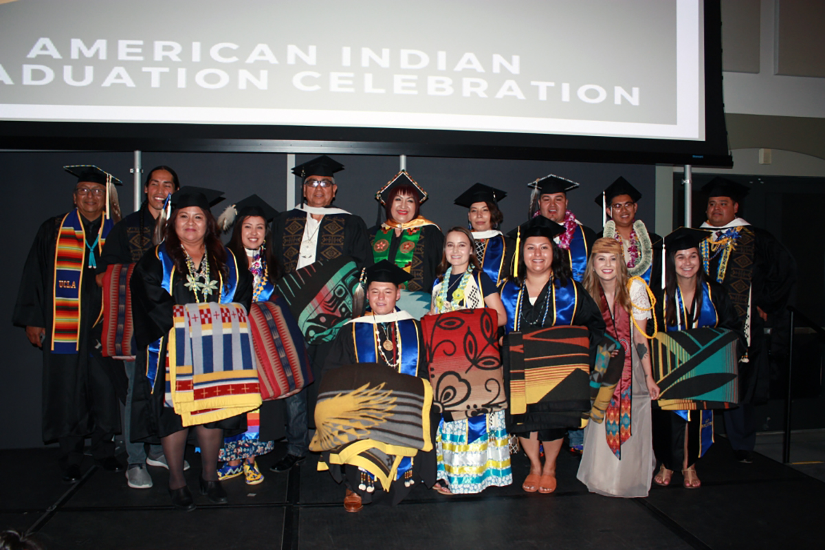 Graduates wearing caps and gowns at the 2-18 American Indian Studies graduation ceremony at UCLA.