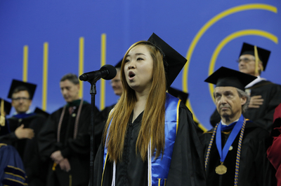 student singing at commencement