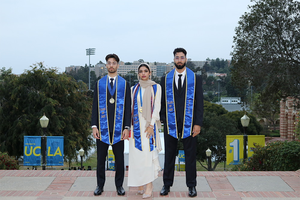 Qasim, Umiemah and Humzah Farrukh standing at the top of Janns steps. 