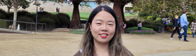 Gloria Jiyoon Kim at the Getty Center, with trees and building in the background