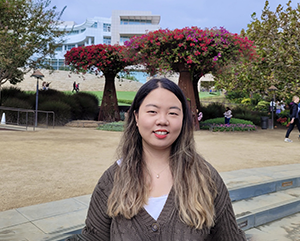Gloria-363 Gloria Jiyoon Kim at the Getty Center, with trees and building in the background