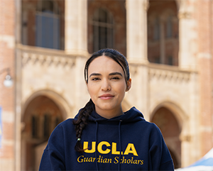 Johanna Carbajal in front of Royce Hall wearing Guardian Scholars hoodie